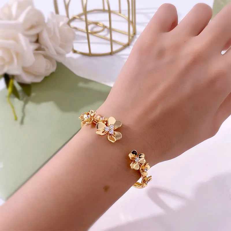 Three-leaf flower bracelet with micro inlaid zircon stones, copper base, electroplated in gold, silver, or rose gold