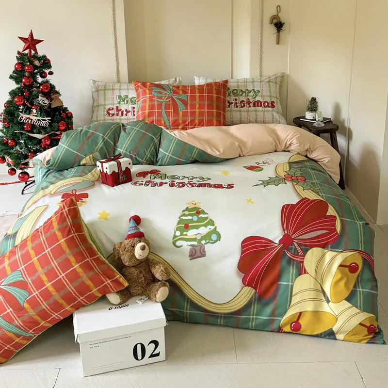 Cartoon Christmas duvet cover and pillowcase set in red and green on a bed.