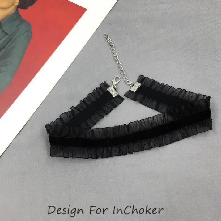 Close-up of a black velvet ruffled chain necklace with a detailed floral alloy pendant.