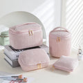 Set of four cube-shaped pink flannelette makeup bags with zips, one showing a removable interior divider and a metal hook.