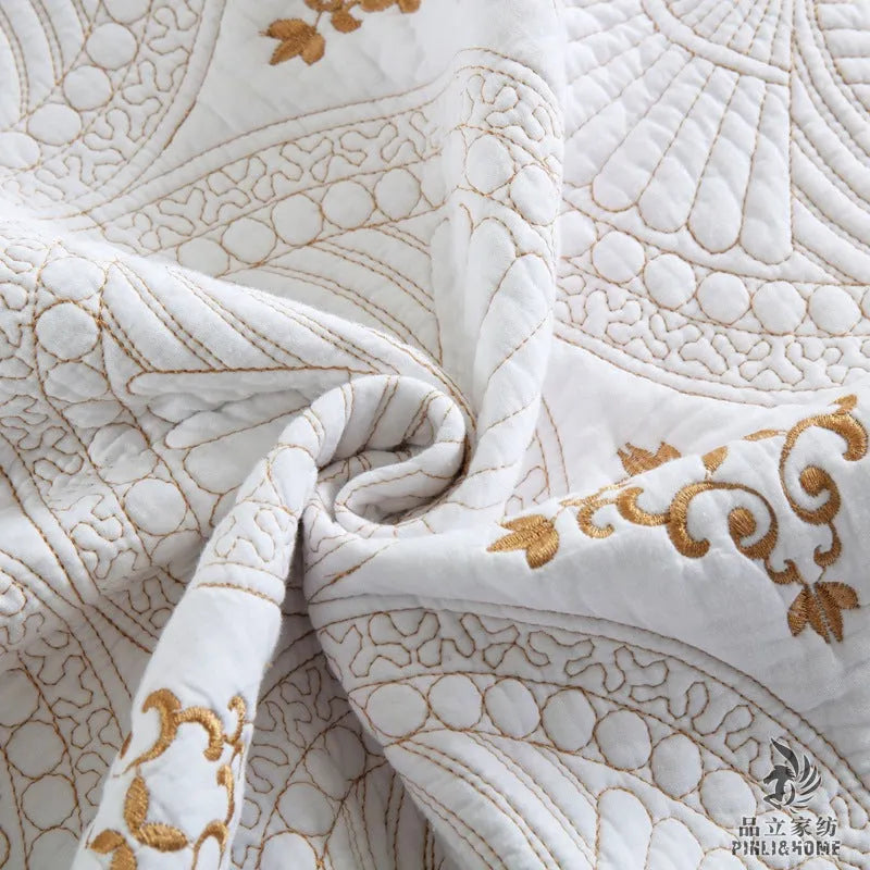 European-style embroidered pure cotton bed cover set with two pillowcases on a bed.