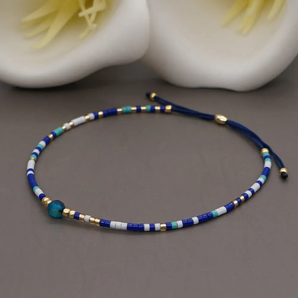 Handmade adjustable women's bracelet with colourful geometric glass and semi-precious stone beads in Bohemian style.