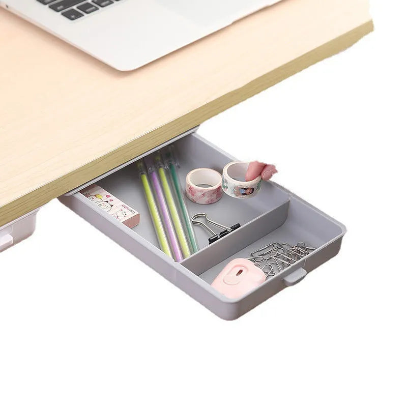 White plastic under-table storage drawer with magnetic adhesive backing and internal grid compartment