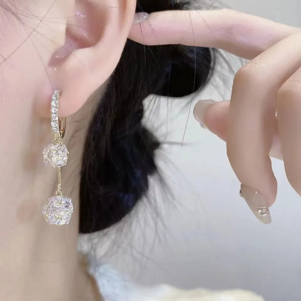 Silver drop earrings with rhinestone ball, balloon charm and tassels on ear clip fitting