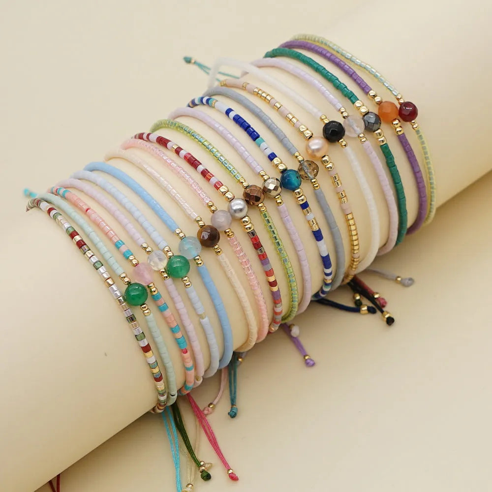 Handmade adjustable women's bracelet with colourful geometric glass and semi-precious stone beads in Bohemian style.