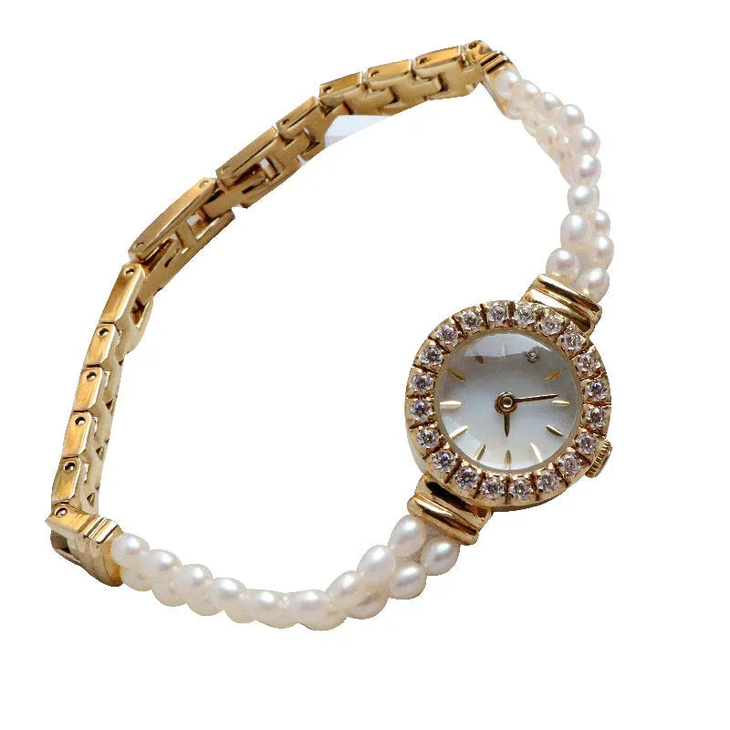 Light gold women's freshwater pearl bracelet watch with round dial on stainless steel strap.