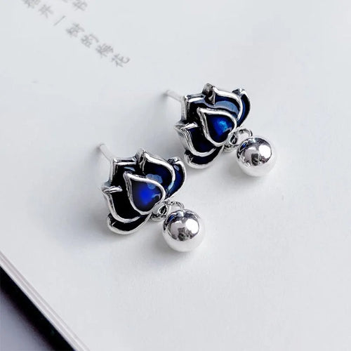 Blue lotus ear studs with seedpod tassel design and retro artistic style