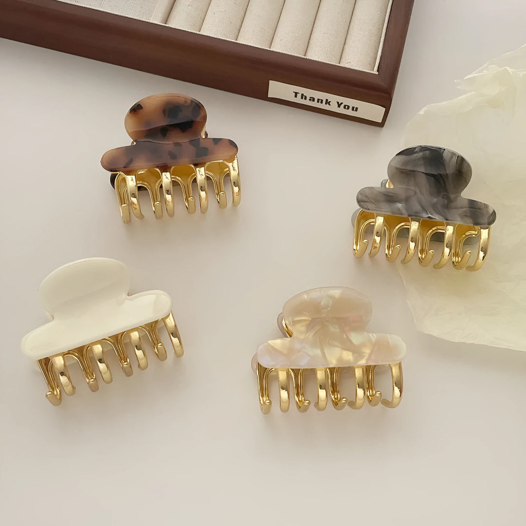 A medium-sized retro acetate hair barrette with a metal grip in a choice of four colours.