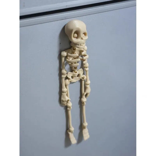3D printed white skull fridge magnet for Halloween decoration, 18cm tall on a refrigerator.