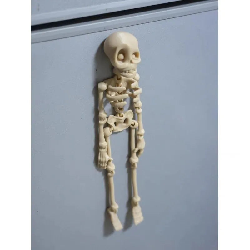 3D printed white skull Halloween fridge magnet, 18cm high, on a refrigerator door.