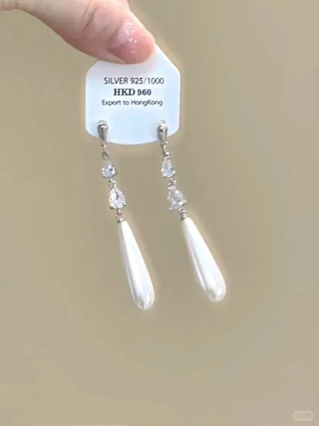 Geometric heart-shaped silver earrings with rhinestones and dangling tassels