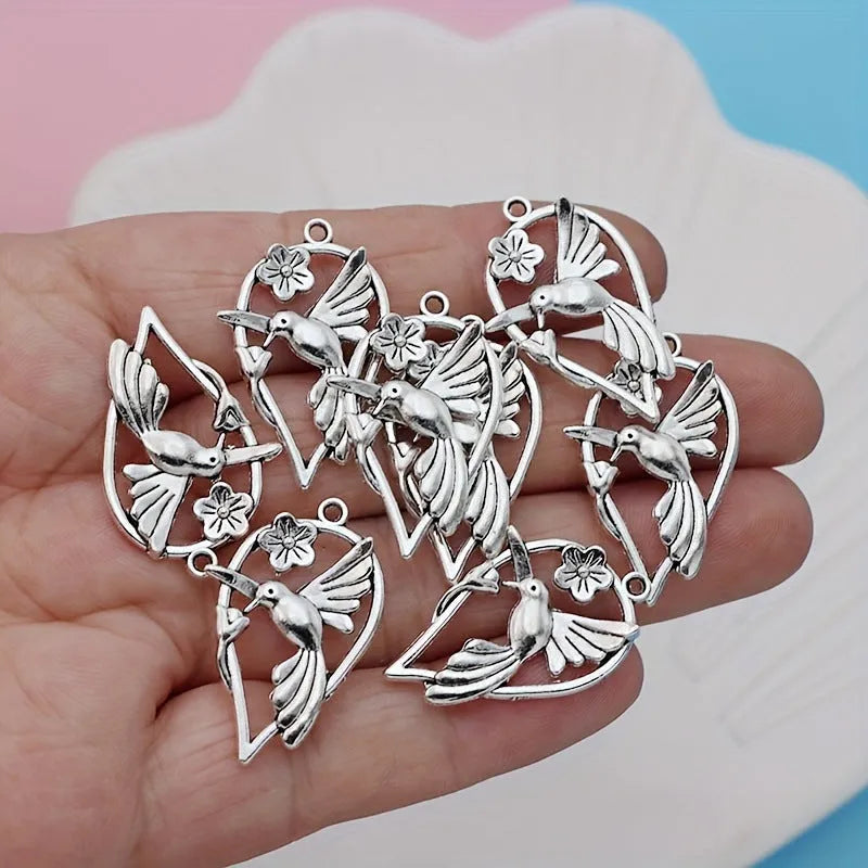 Gold tone alloy pendant with a detailed cast magpie design, shown from the front and back.