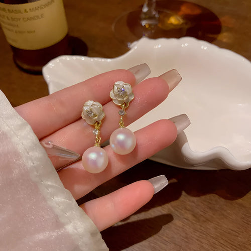 A pair of camellia flower-shaped stud earrings for women in alloy.