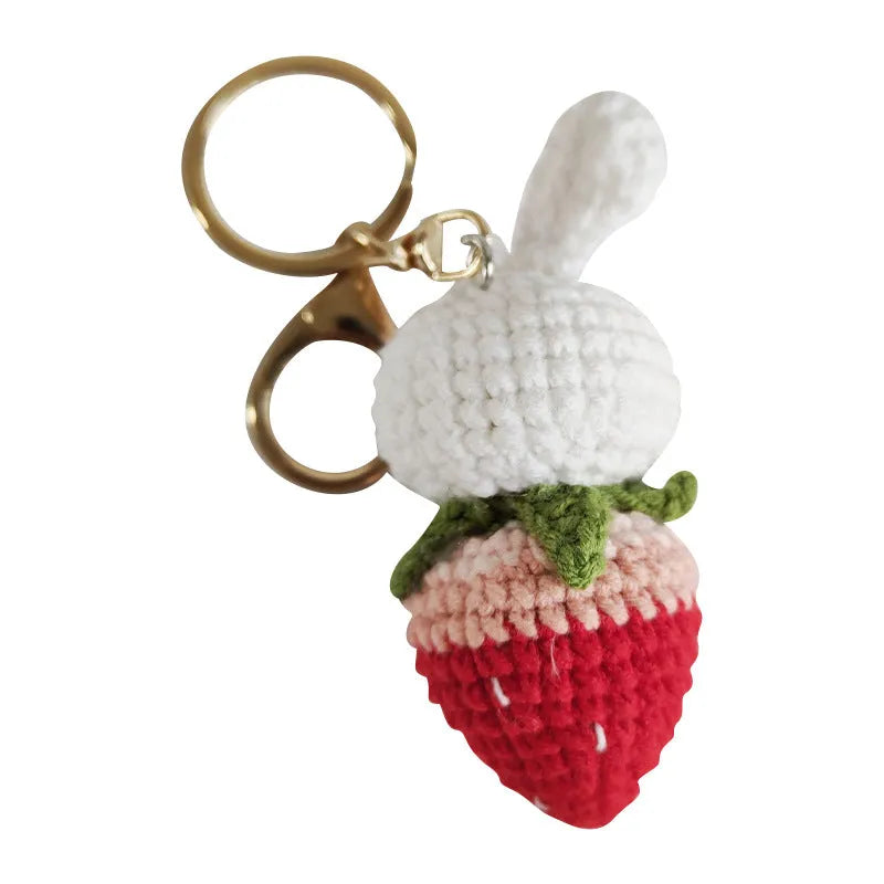 Hand-woven white doll wire pendant with a rabbit strawberry charm and an attached key