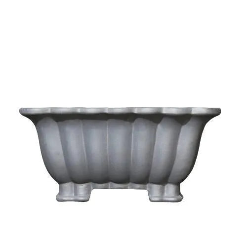 Square purple sand ceramic bonsai pot with du xiliang glaze on a desktop.