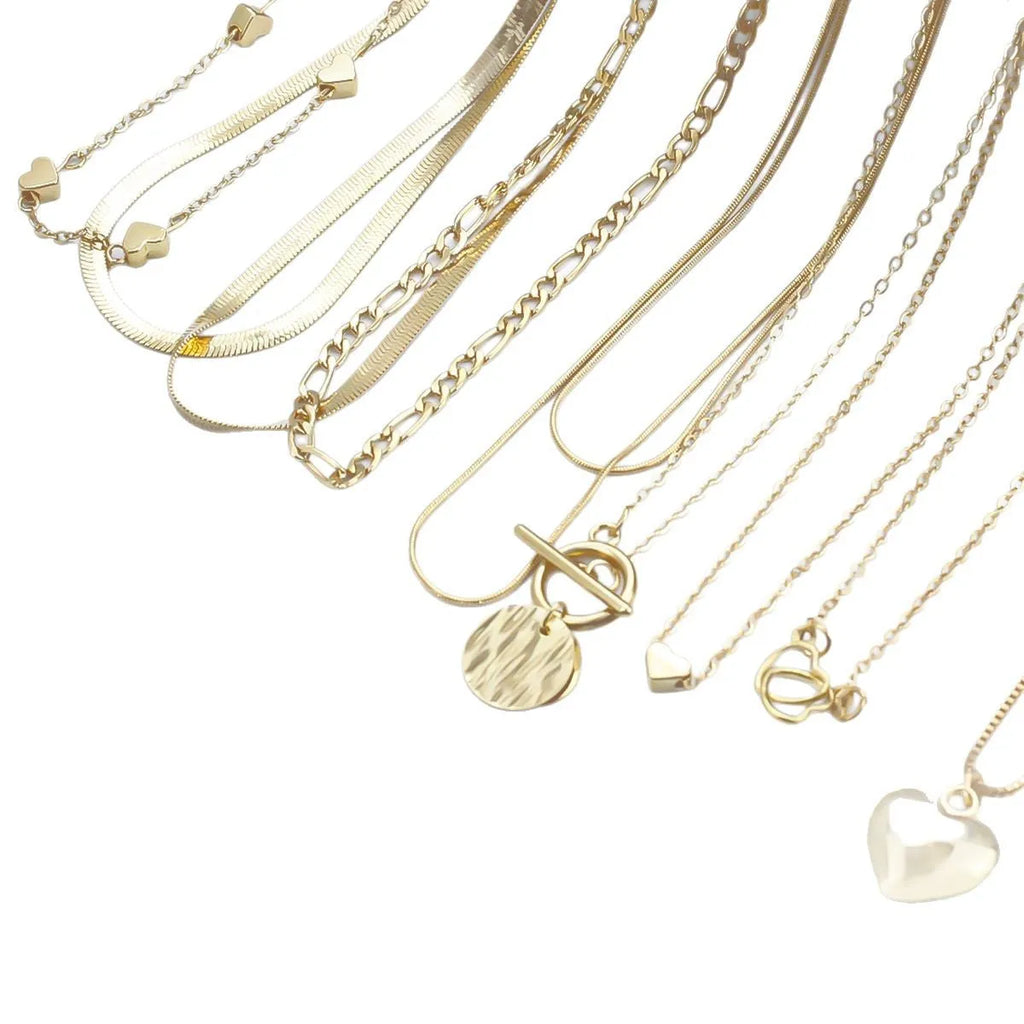 Set of ten gold-coloured women's necklaces with snake bone chains and alloy pendants on a white background.