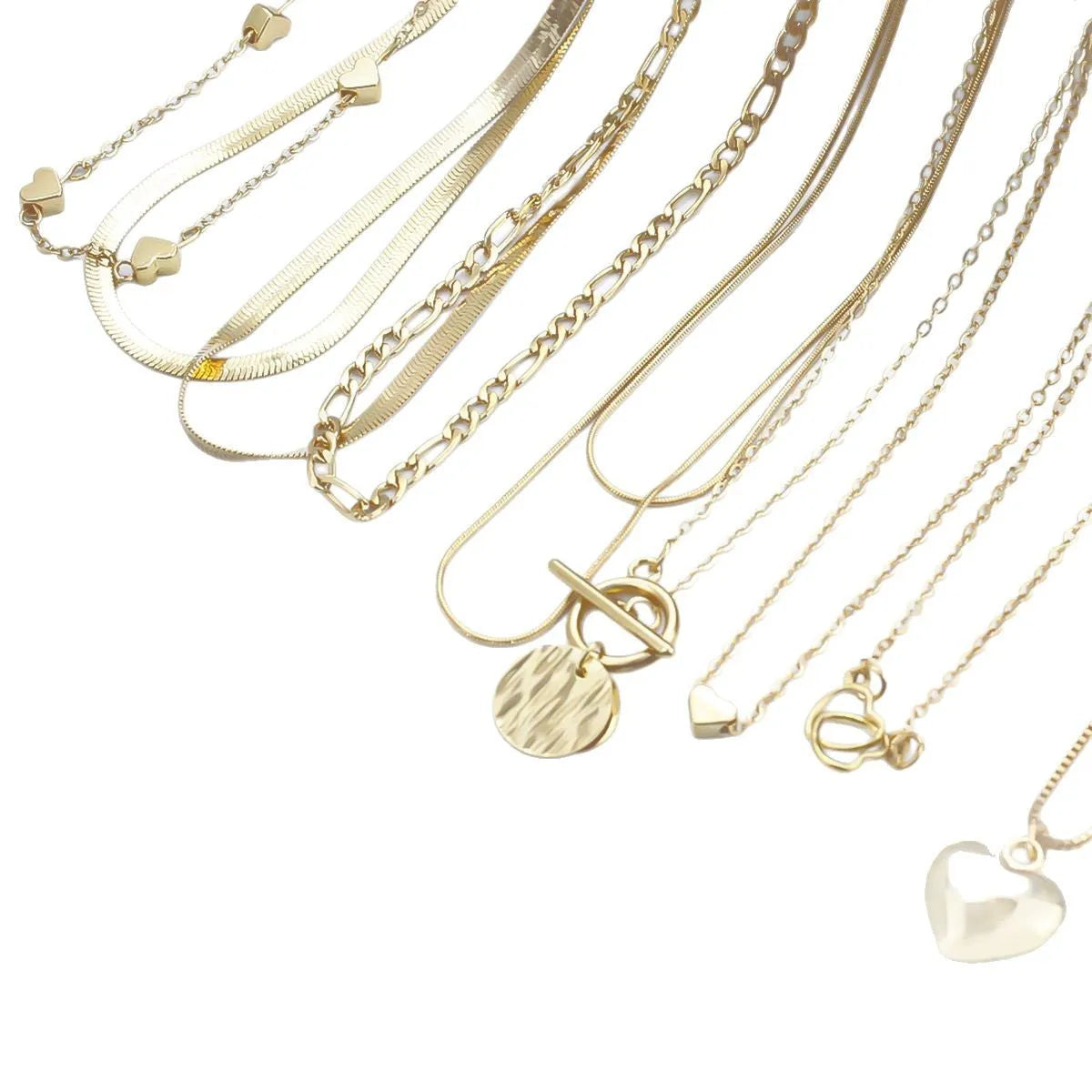Set of ten gold-coloured women's necklaces with snake bone chains and alloy pendants on a white background.