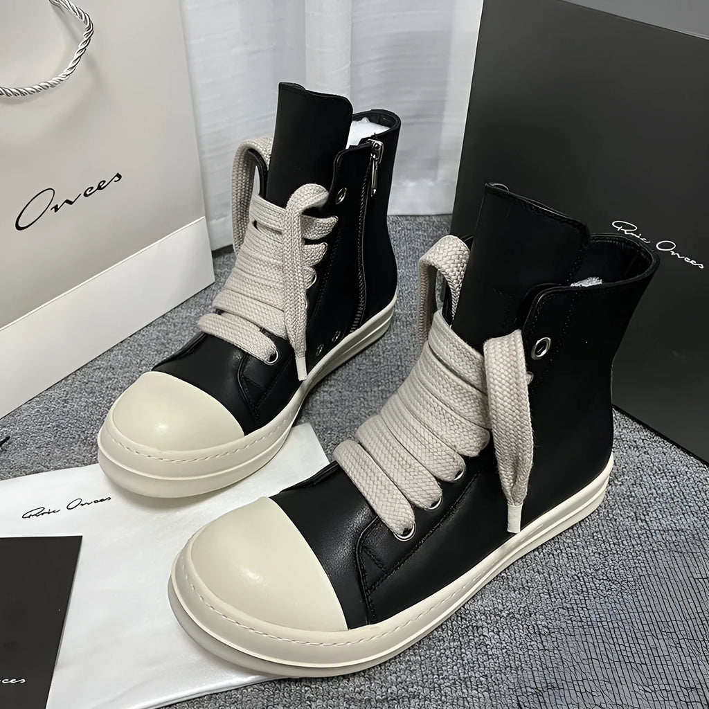 Black genuine leather high-top sneakers with a side zipper and round toe on a rubber sole.