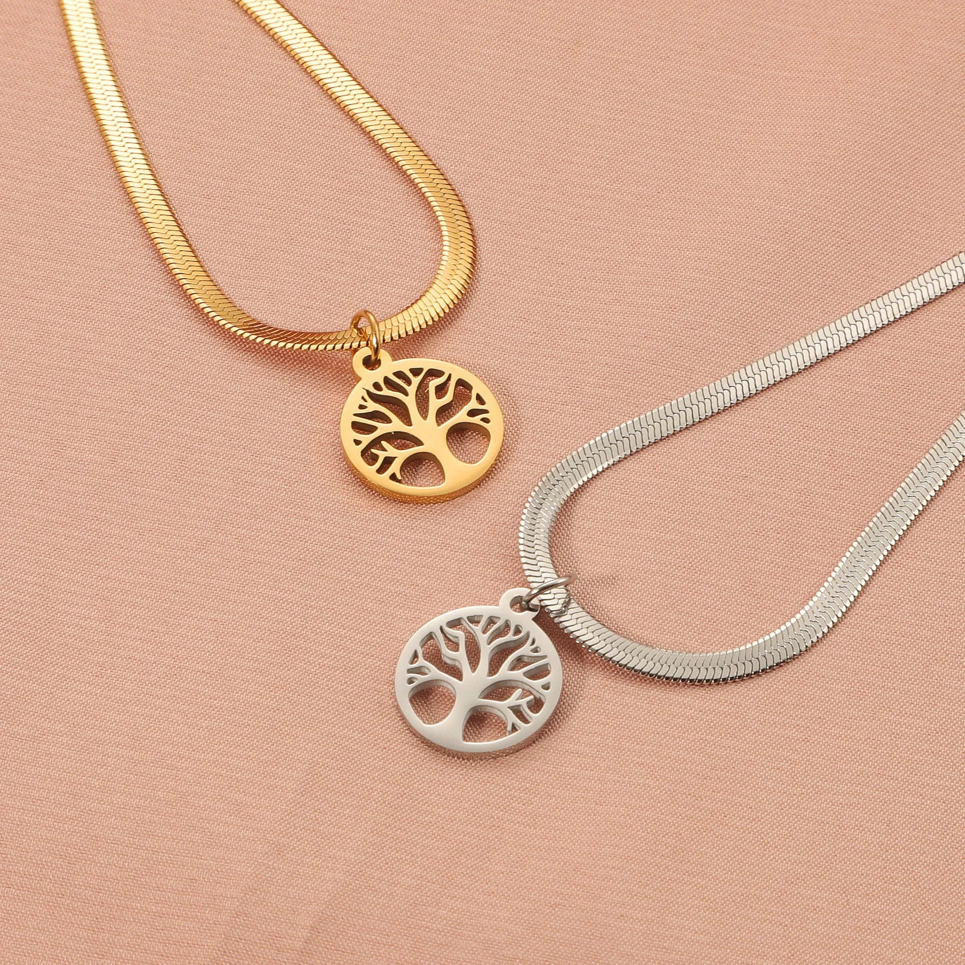 Stainless steel necklace with lucky tree pendant on a textured snake bones chain.