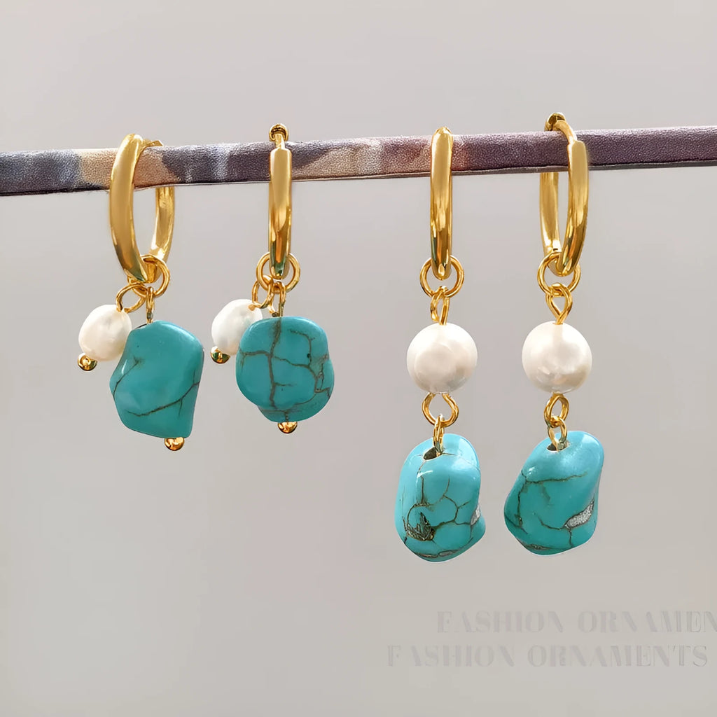 A pair of geometric copper earring clips with turquoise stones and cultured pearls, one short and one long.