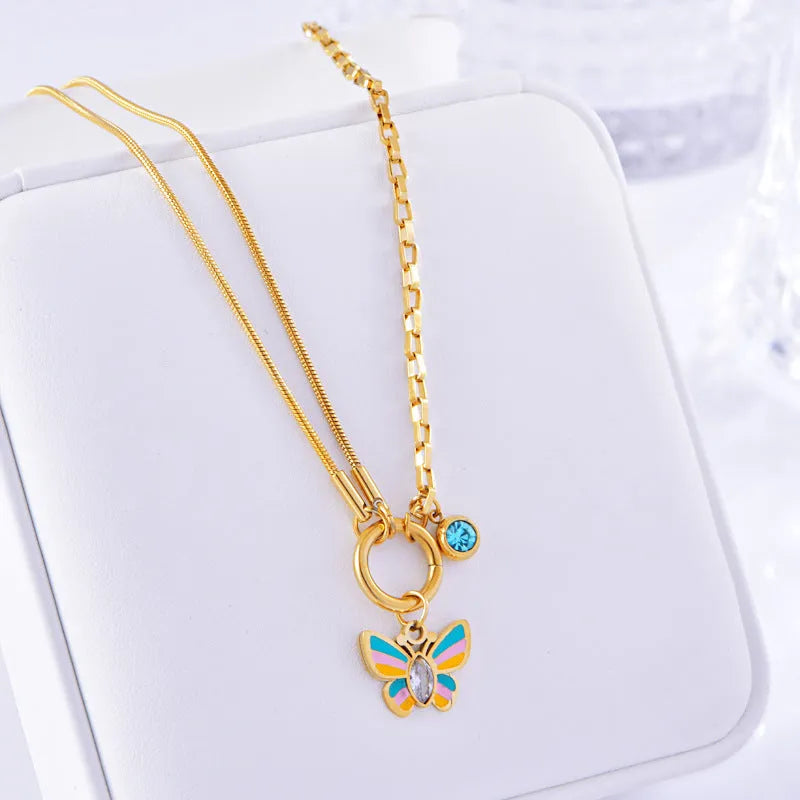 Gold tone titanium steel necklace and bracelet set with colourful epoxy butterfly pendants on a snake bone chain.