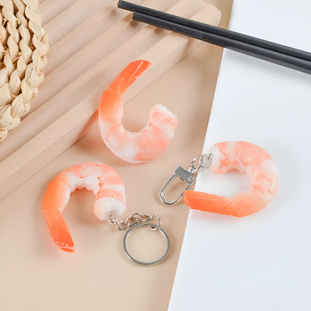 PVC injection moulded shrimp-shaped keychain and bag pendant with door buckle on white background.