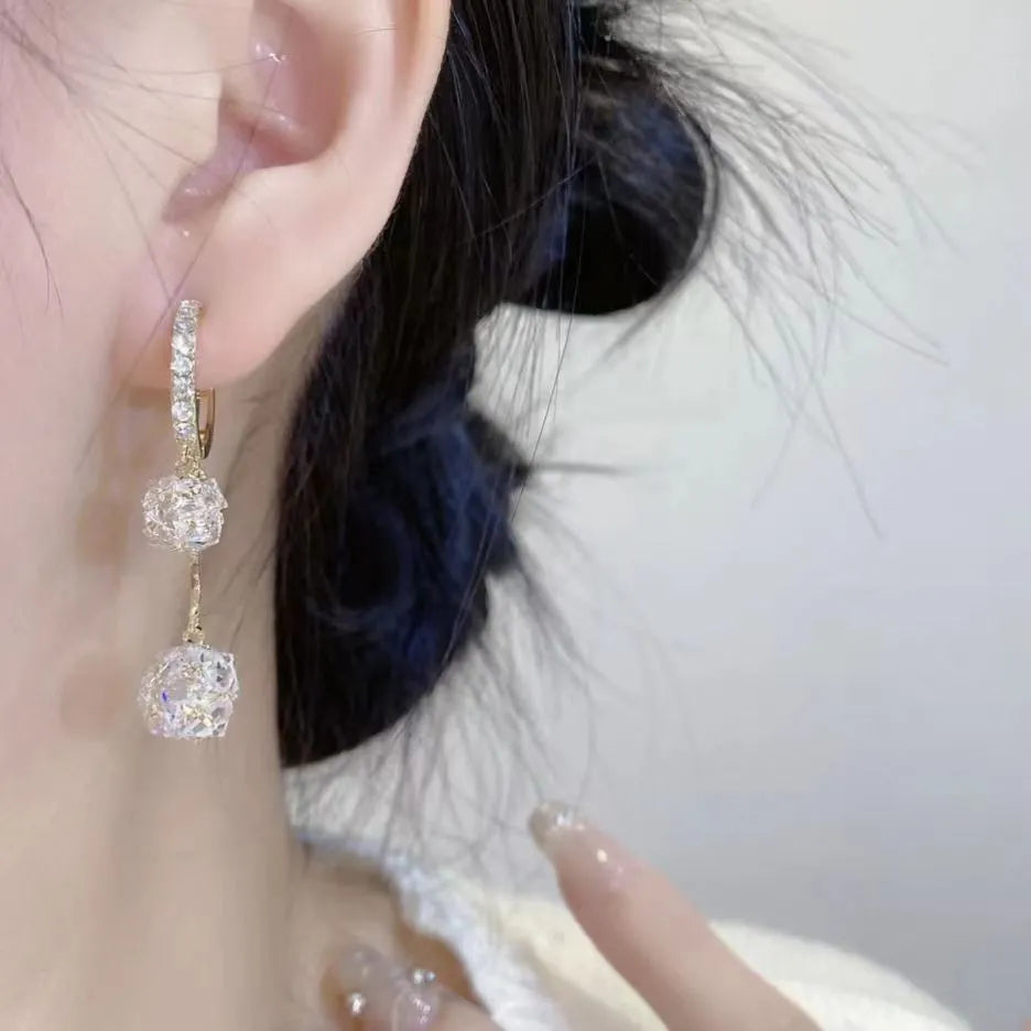 Silver drop earrings with rhinestone ball, balloon charm and tassels on ear clip fitting