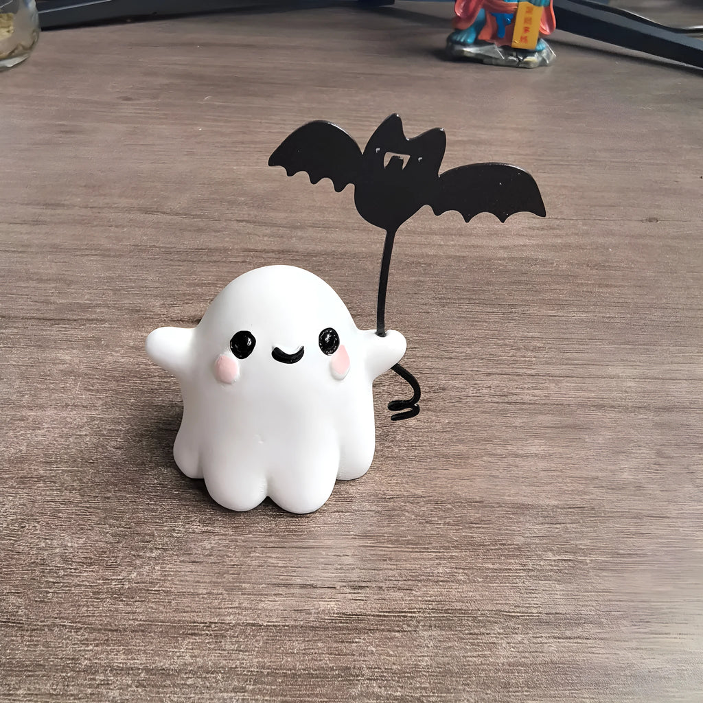 Miniature white ghost dog walking statue holding a small black bat, resin Halloween ornament