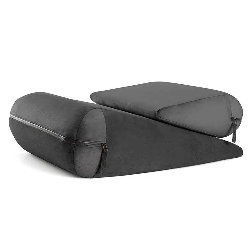 Grey embroidered triangle cushion on a sofa, showing its 68cm wedge shape for back support.