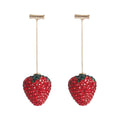 A pair of red geometric strawberry stud earrings with a faceted surface and butterfly clutch fastenings.
