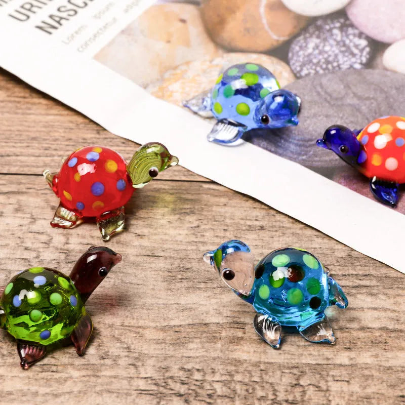 Modern geometric glass turtle ornament on a desk in blue head and blue shell colour variation.