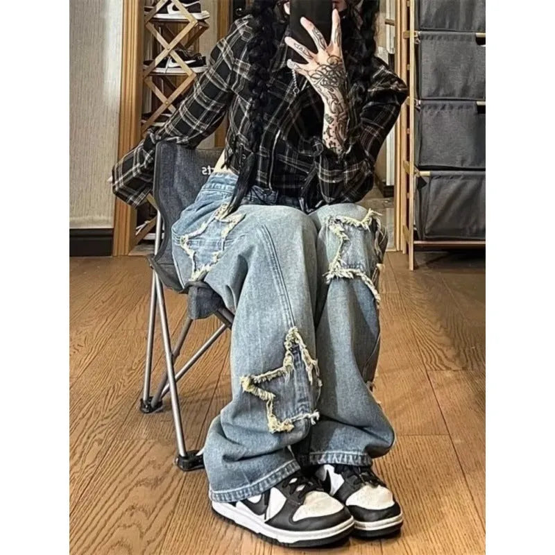 Women's blue high-waisted straight-leg jeans laid flat on a surface.