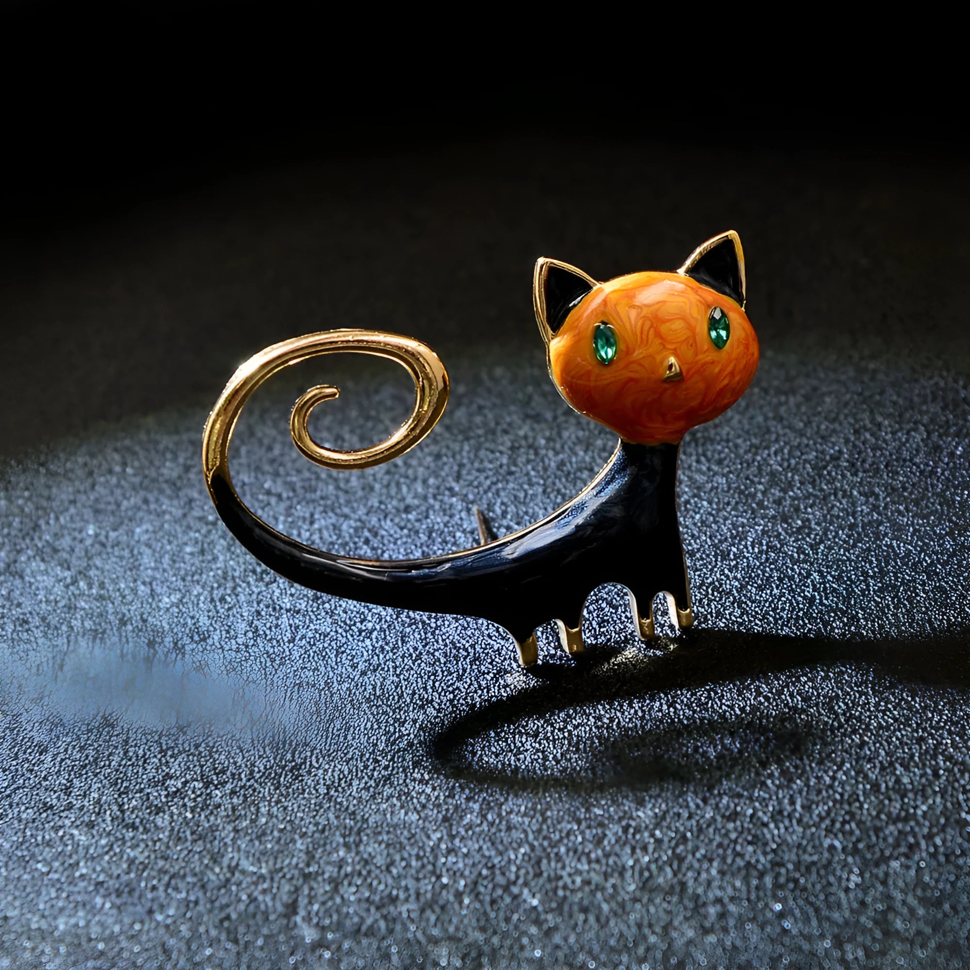 Orange and white alloy cat brooch with painted tail detail and pin fastener.