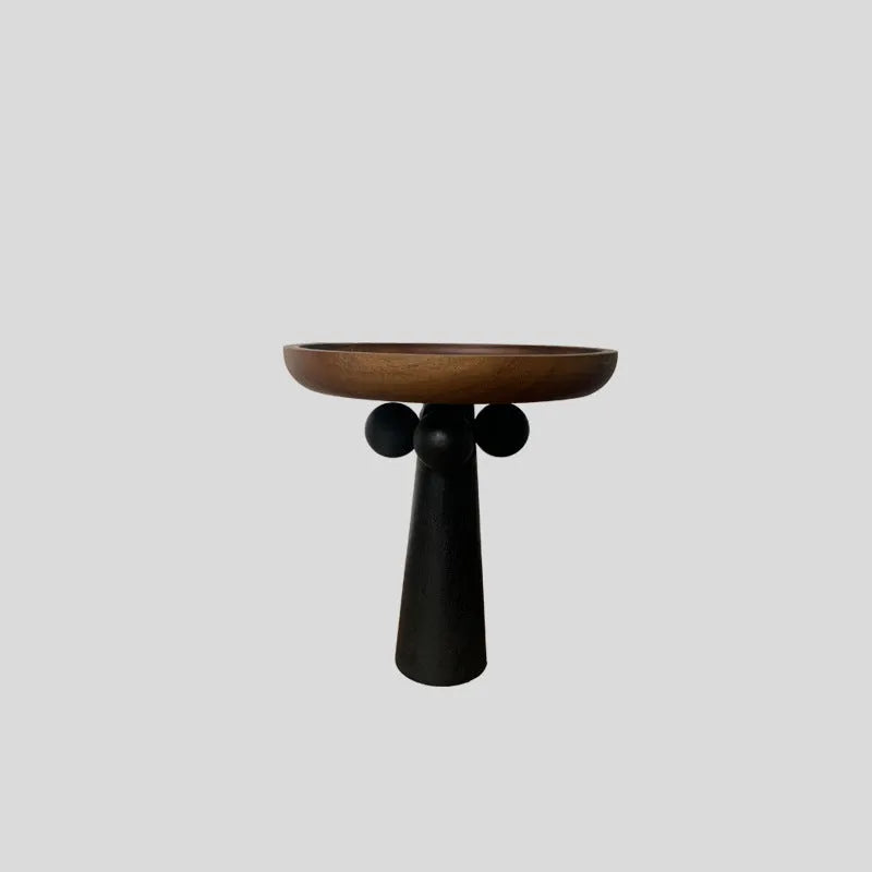 Nordic style round wooden tray with high legs for displaying candles and aromatherapy items.