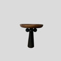Nordic style round wooden tray with high legs for displaying candles and aromatherapy items.