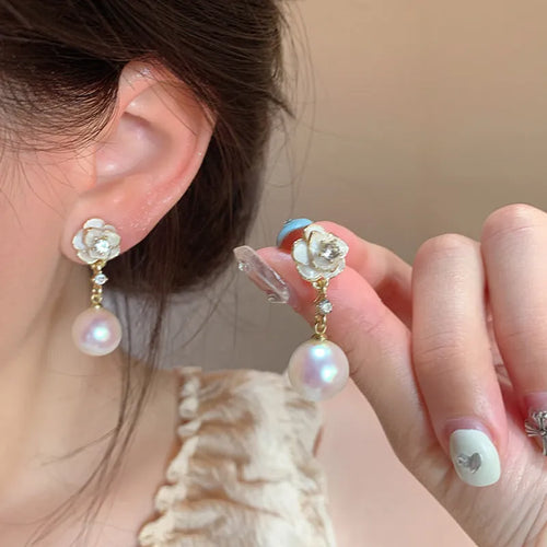 A pair of camellia flower-shaped stud earrings for women in alloy.