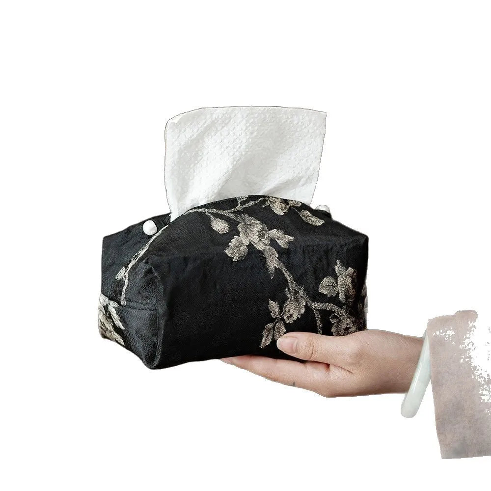 White embroidered plum blossom brocade tissue box cover with pearl buckle on table