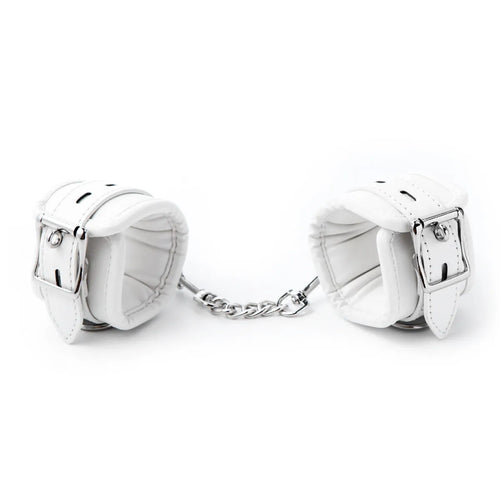White PU sponge bondage set showing handcuffs, foot cuffs, and a neck scarf arranged together.