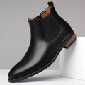 Men's black pointed-toe Chelsea boots with a low heel and rubber sole on a white background.