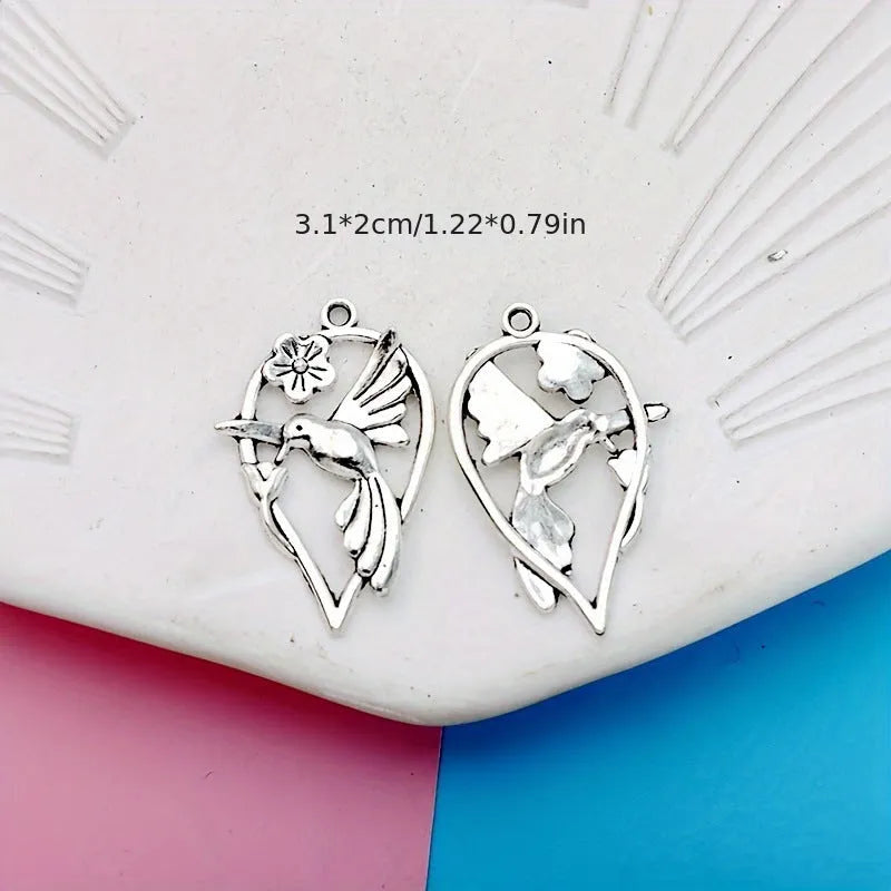 Gold tone alloy pendant with a detailed cast magpie design, shown from the front and back.