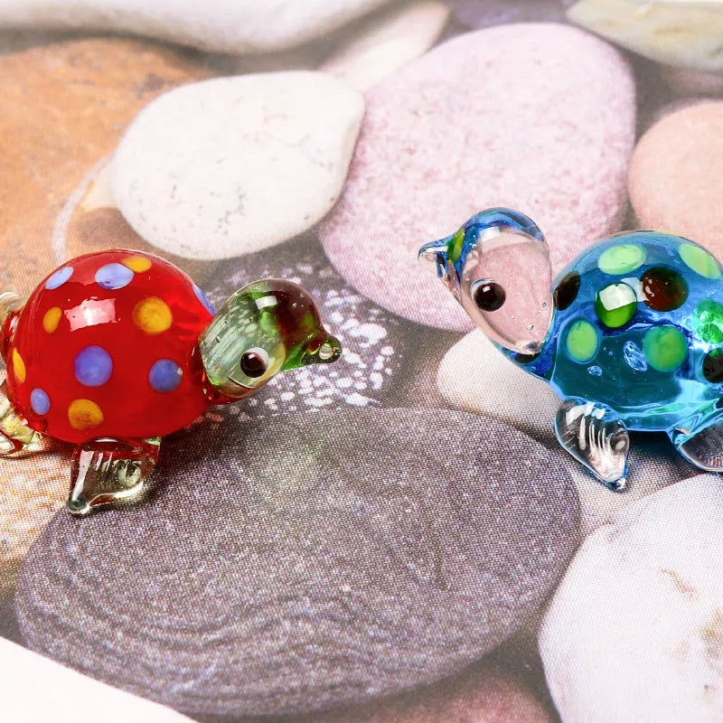 Modern geometric glass turtle ornament on a desk in blue head and blue shell colour variation.