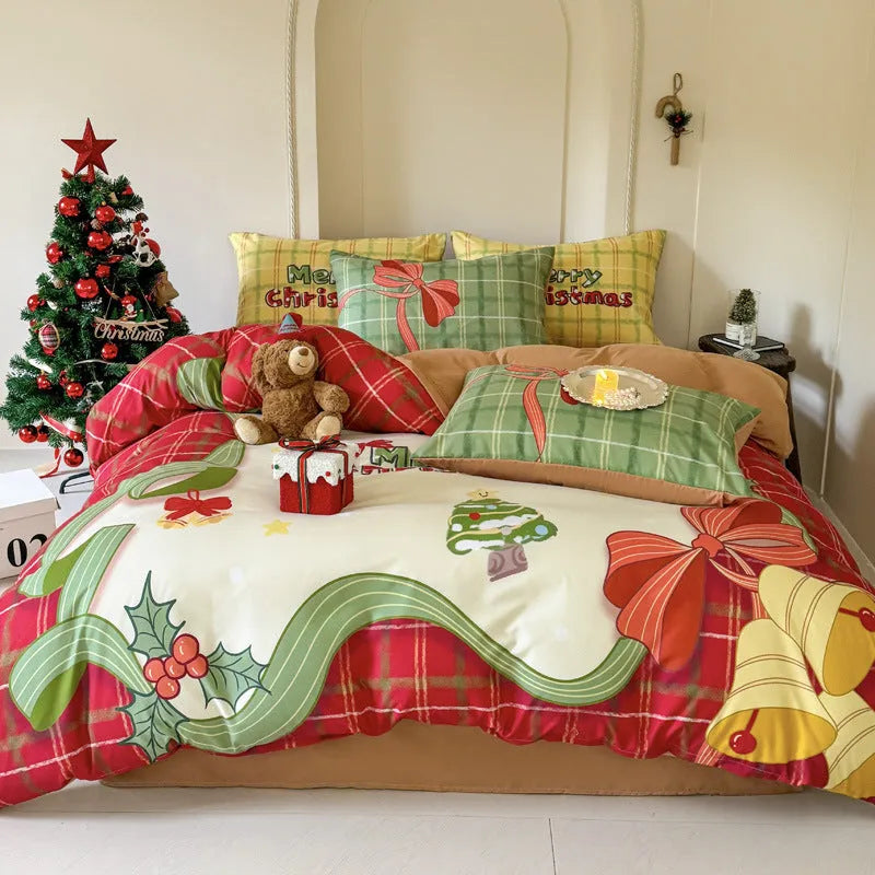 Cartoon Christmas duvet cover and pillowcase set in red and green on a bed.