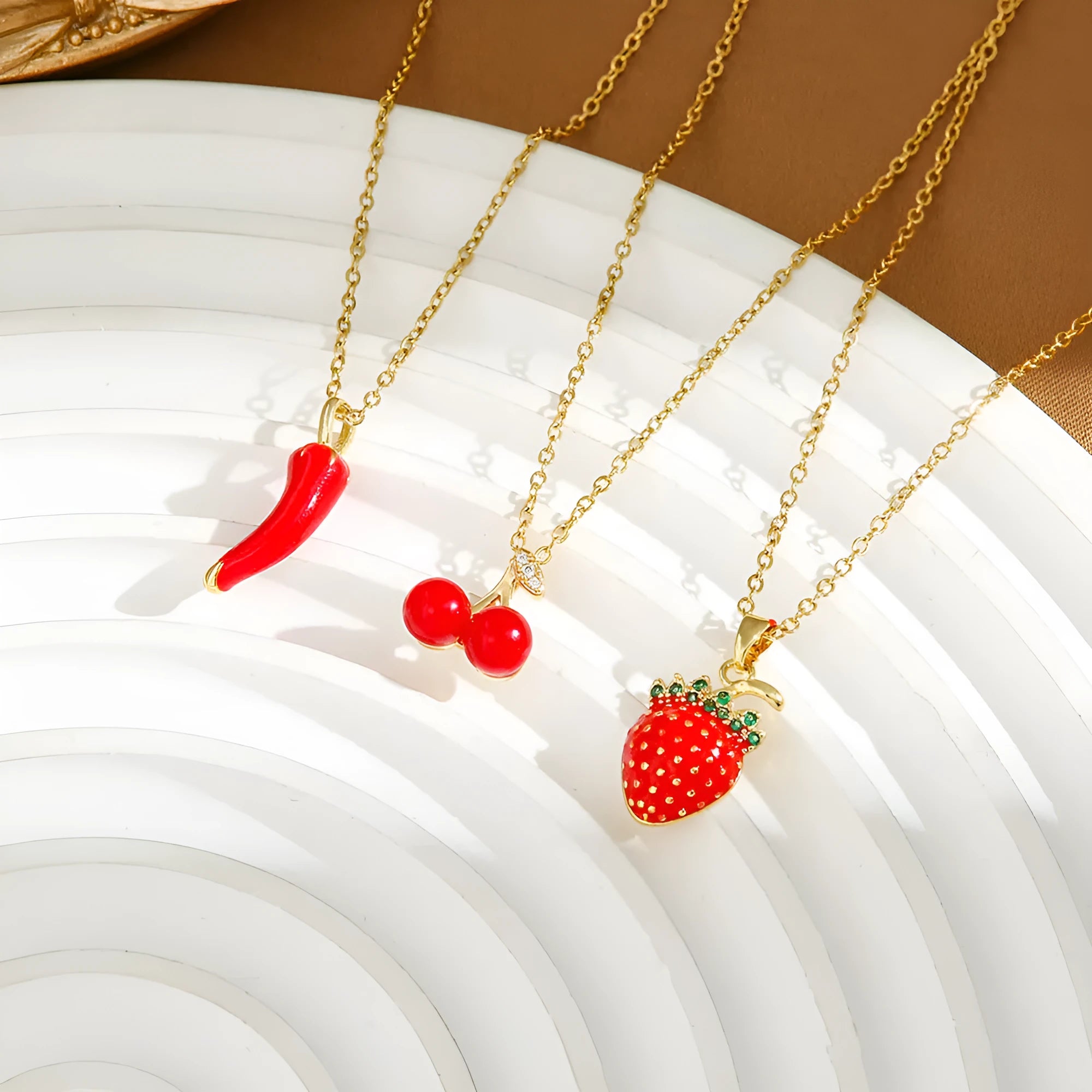 Red delicate indie necklace with cherry charm on a 50cm adjustable titanium steel O-ring chain.