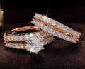 2 in 1 fully jewelled female fashion ring set in silver, gold, and rose gold on a geometric background.