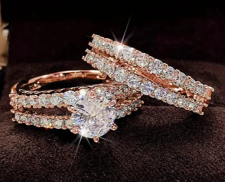 2 in 1 fully jewelled female fashion ring set in silver, gold, and rose gold on a geometric background.