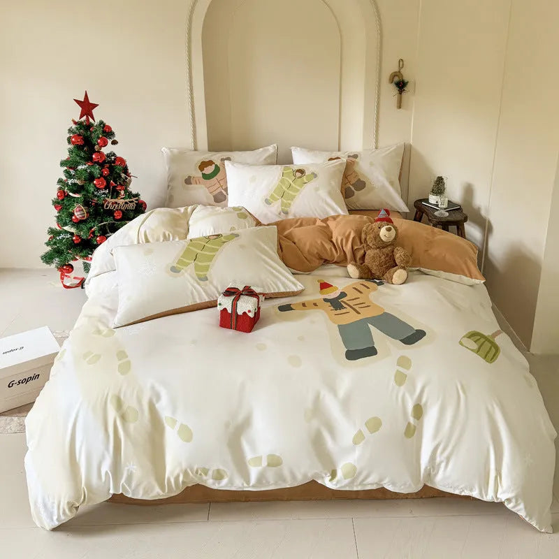 Cartoon Christmas duvet cover and pillowcase set in red and green on a bed.