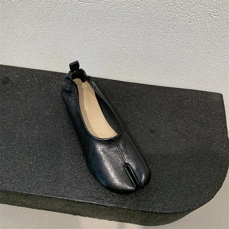 Women's round toe pumps with a split toe horseshoe design and a low chunky heel.