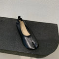 Women's round toe pumps with a split toe horseshoe design and a low chunky heel.