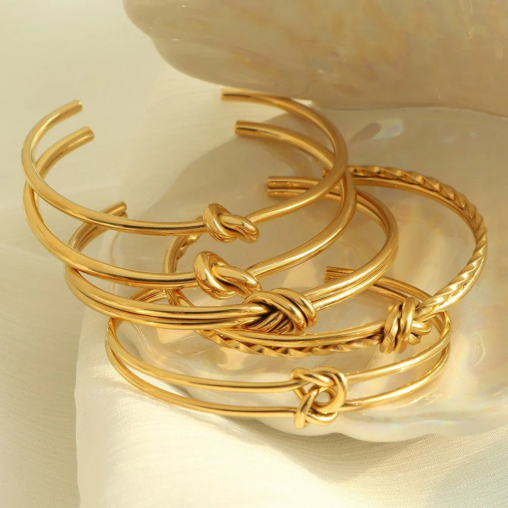 Women's adjustable knotted C-shaped bracelet in stainless steel with gold plating
