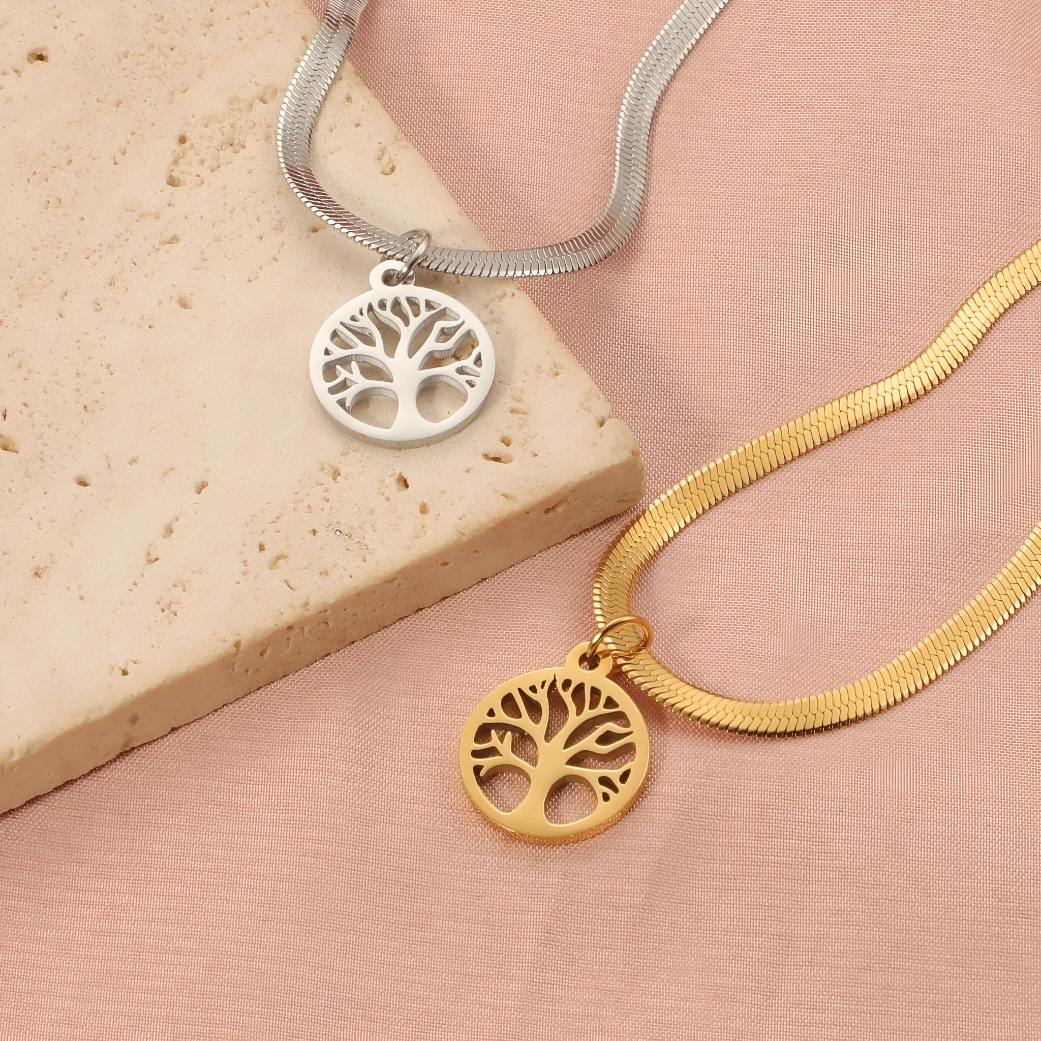 Stainless steel necklace with lucky tree pendant on a textured snake bones chain.